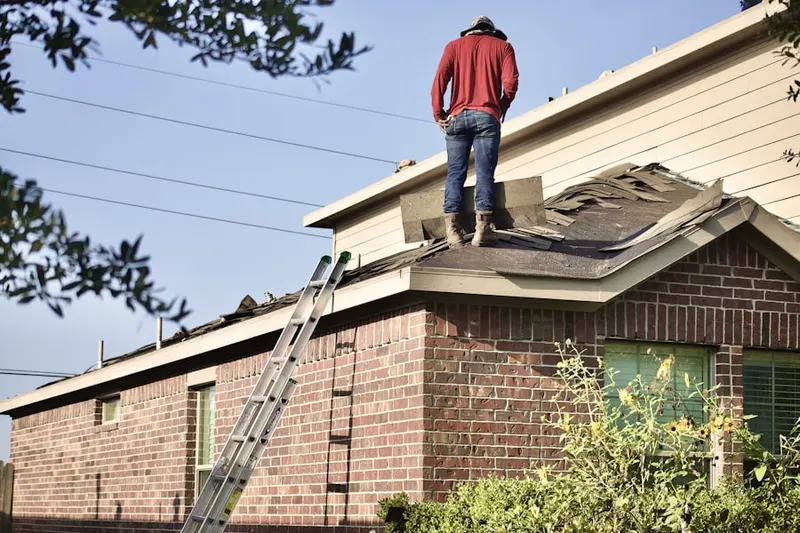 Professional roofer working on a residential roof in Pine View